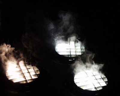 Steam rising off lights in a cold rain - Taken with an Olympus Camedia c2500l back in 2003 (at least)
